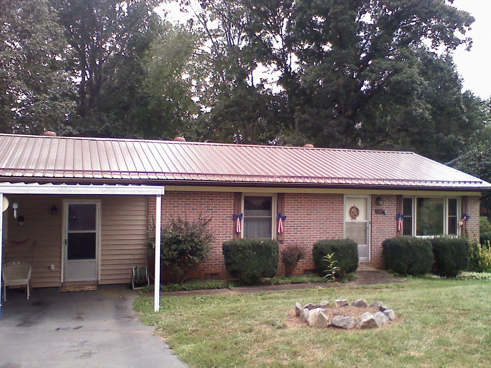 Bronze metal roof and carport on a brick ranch home — Roof Repair work by our crew in Auburn